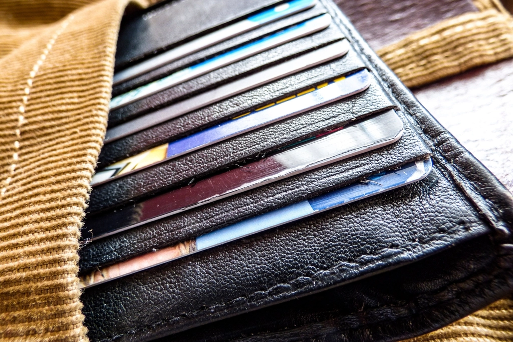 Payment cards tucked into the slots of a black leather wallet
